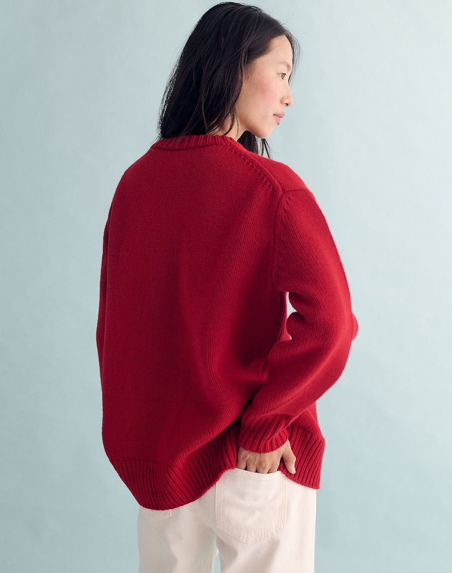 Person wearing a red sweater against a light gray background